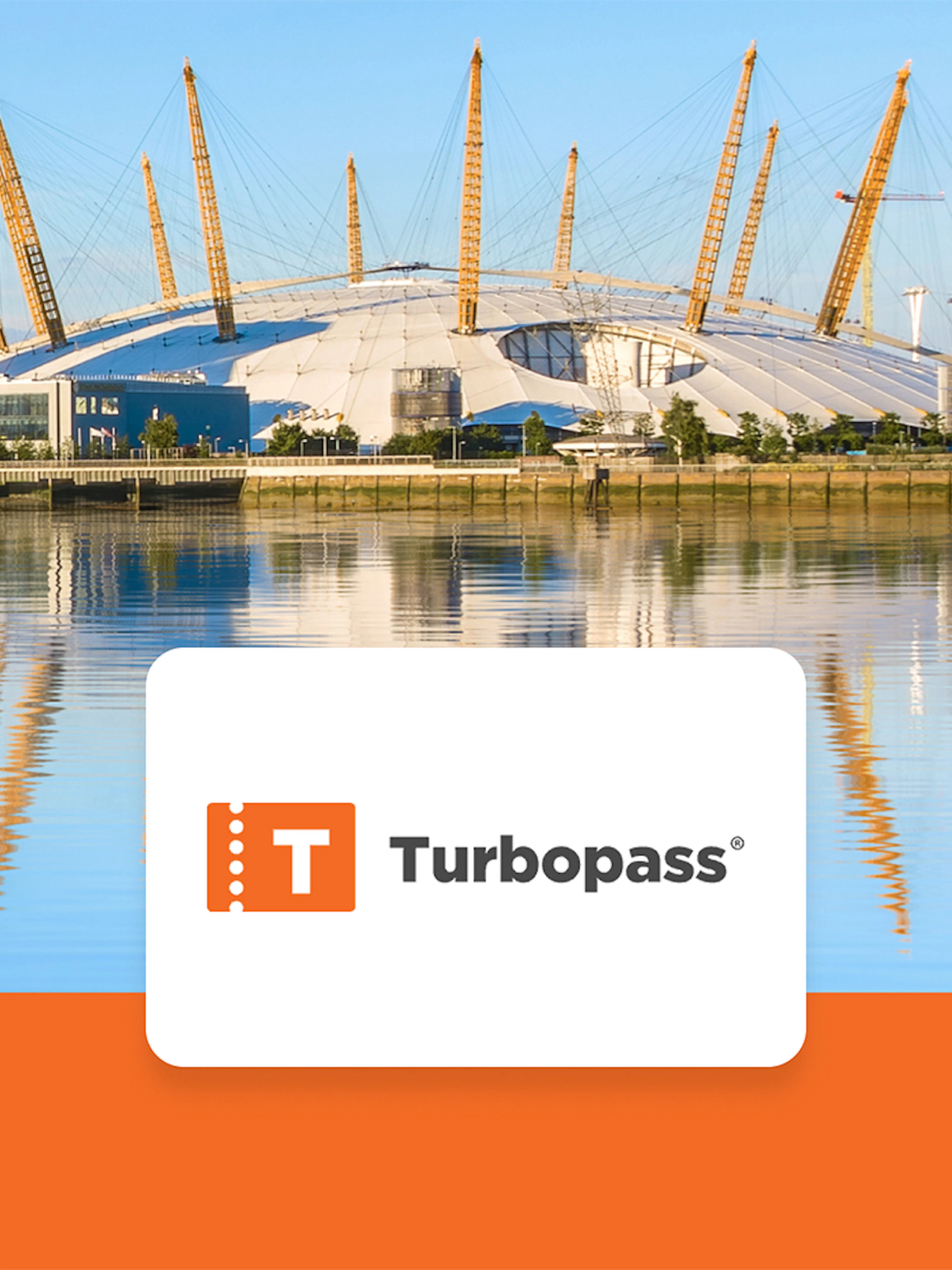 The O2 Arena in London with surrounding buildings and cranes reflected in the Thames River.