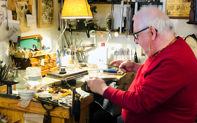 Craftsman working on amber jewelry at a workshop in Gdańsk.