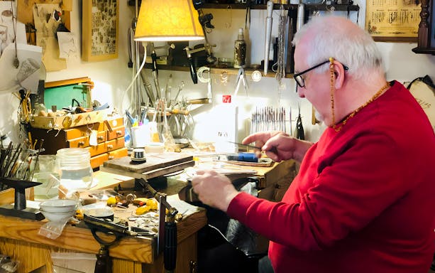 Craftsman working on amber jewelry at a workshop in Gdańsk.