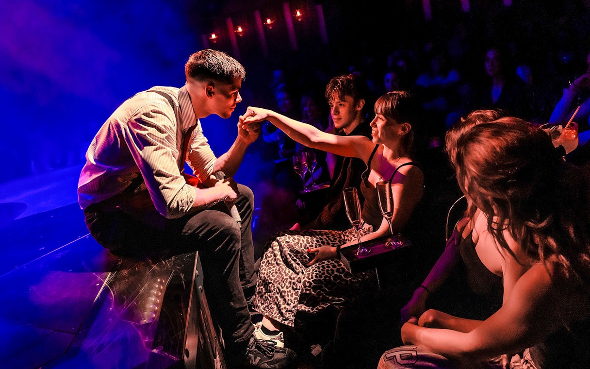 Performer interacting with audience at Magic Mike Live show.