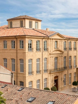 Hotel De Caumont facade with classic architecture in Aix-en-Provence, France.