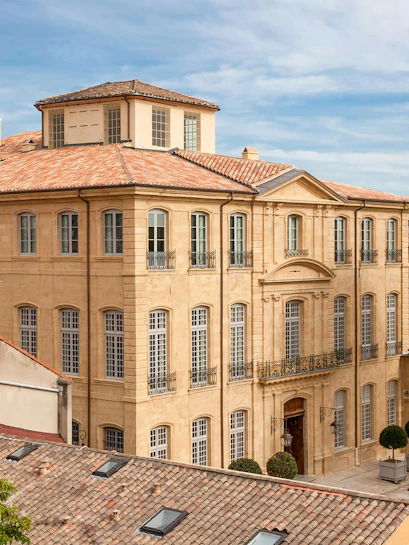 Hotel De Caumont facade with classic architecture in Aix-en-Provence, France.