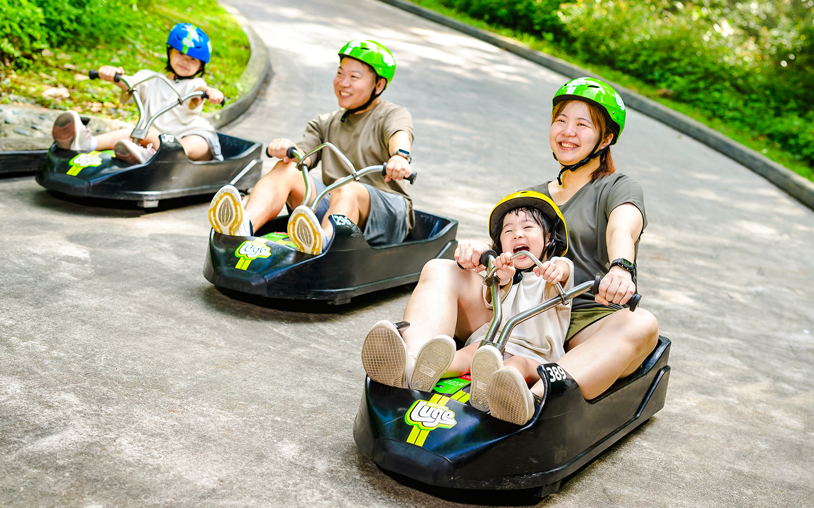 Family enjoying Skyline Luge ride in Singapore.