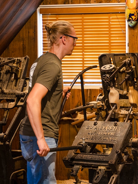 Traditional clog making demonstration with machinery and wooden clogs on display.