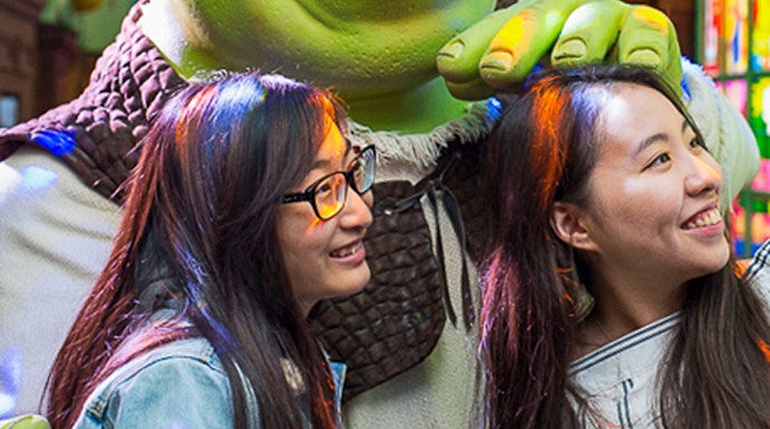Visitors posing with Shrek at Shrek's Adventure in London.