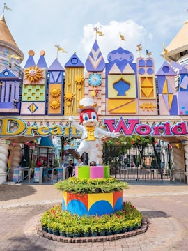 Dream World entrance with colorful architecture and character statue, Bangkok.