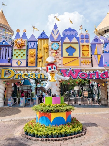 Dream World entrance with colorful architecture and character statue, Bangkok.