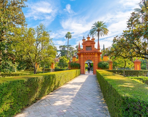 The ornate landscaped grounds and gardens inside the Royal Alcázar of Seville, a 10th century palace in the historic center of Seville, Spain