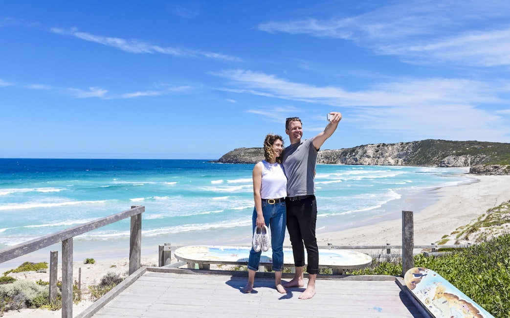 Couple taking a selfie on a boardwalk overlooking the beach at Kangaroo Island.