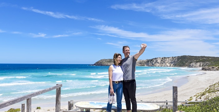 Couple taking a selfie on a boardwalk overlooking the beach at Kangaroo Island.