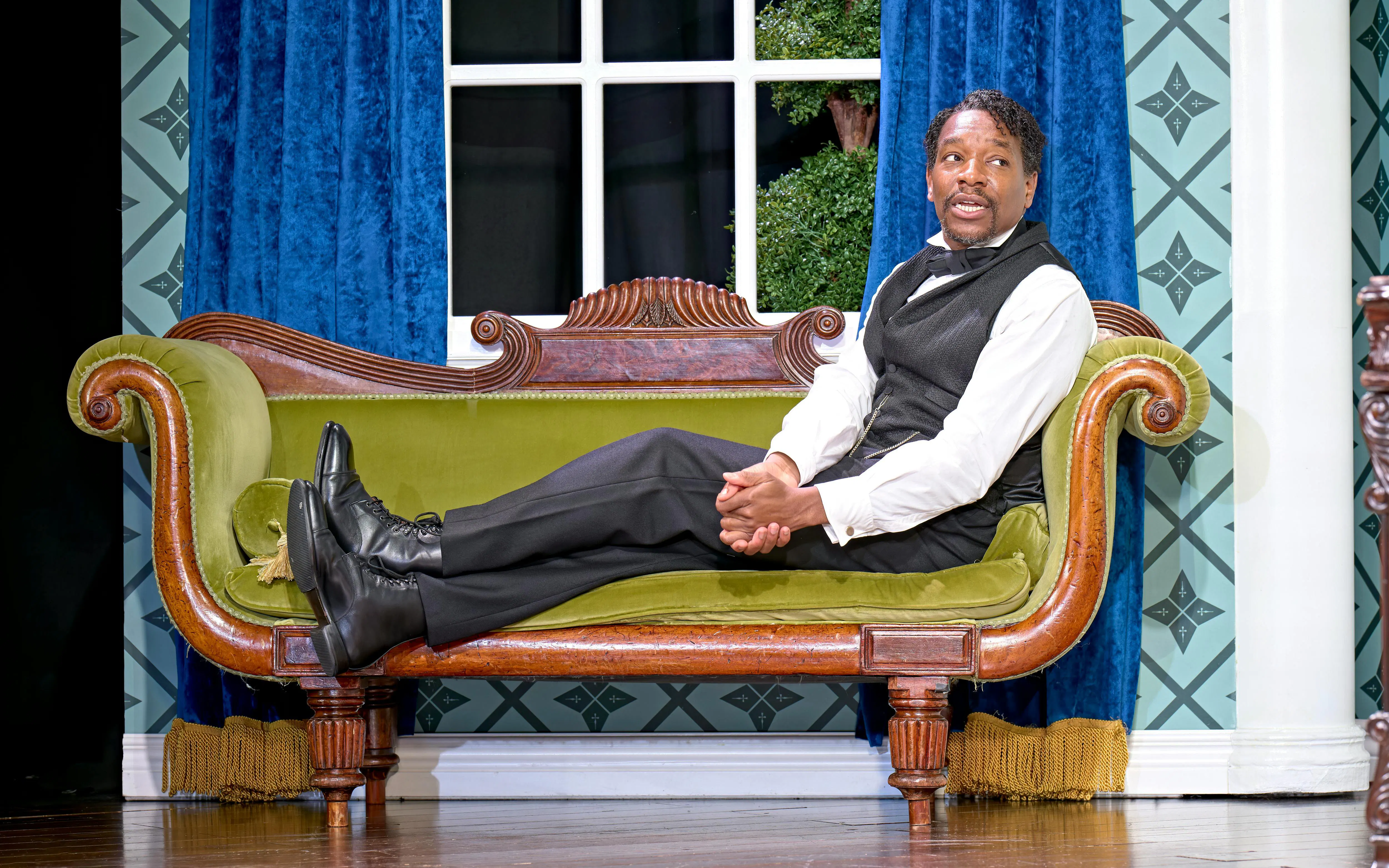 Actor in period costume on stage during "Oh Mary" play, West End theater.
