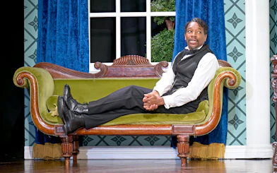 Actor in period costume on stage during "Oh Mary" play, West End theater.