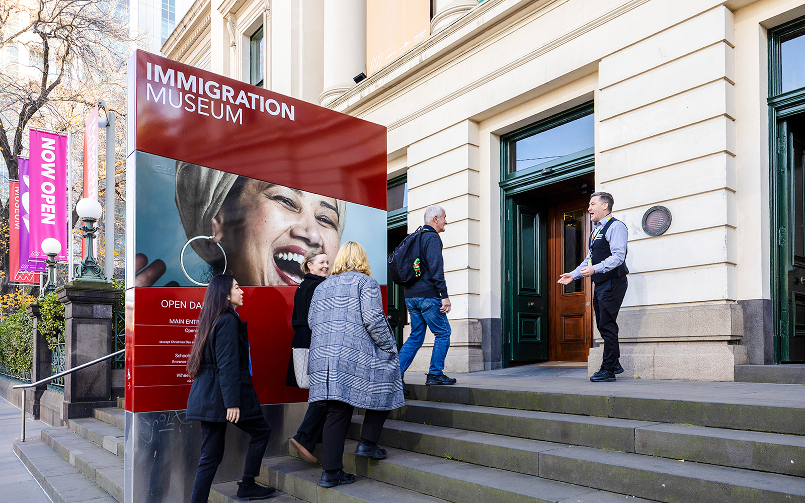Visitors entering Immigration Museum for guided highlights tour.