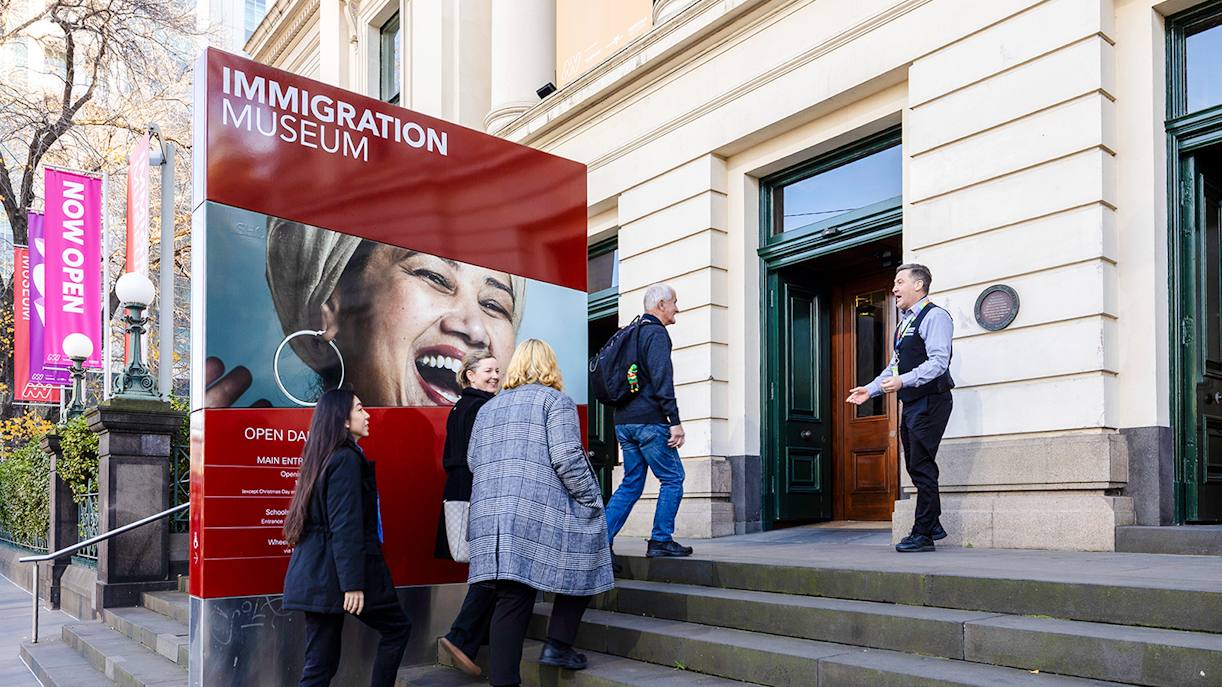 Visitors entering Immigration Museum for guided highlights tour.