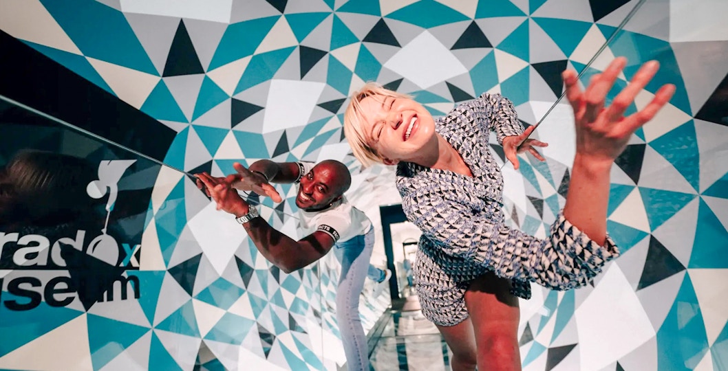 Visitors exploring optical illusions at Paradox Museum, France.