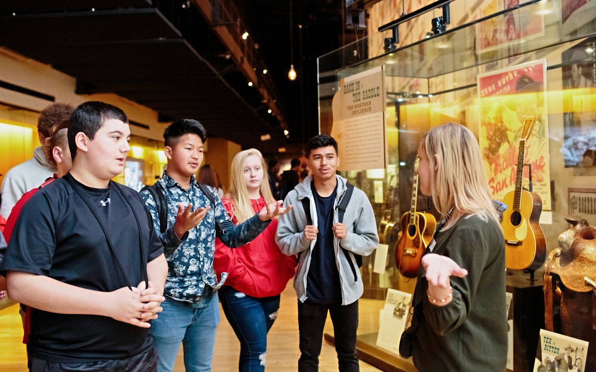 Guide leading a group through the Country Music Hall of Fame and Museum in Nashville, Tennessee.