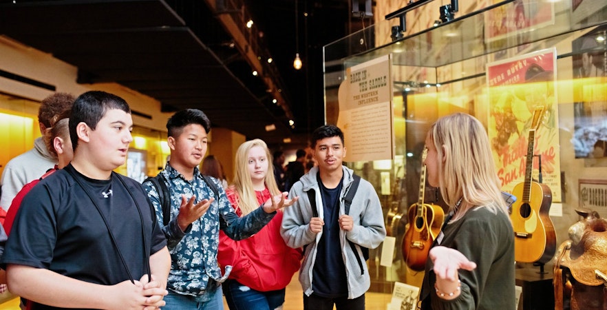 Guide leading a group through the Country Music Hall of Fame and Museum in Nashville, Tennessee.