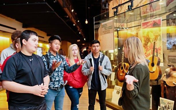 Guide leading a group through the Country Music Hall of Fame and Museum in Nashville, Tennessee.