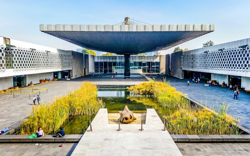 Anthropology museum entrance with courtyard pond and unique roof structure.