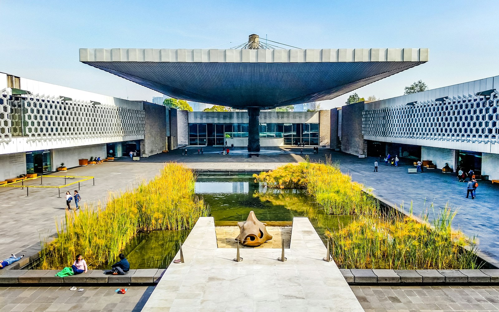 Anthropology Museum entrance with visitors exploring exhibits in Mexico City.