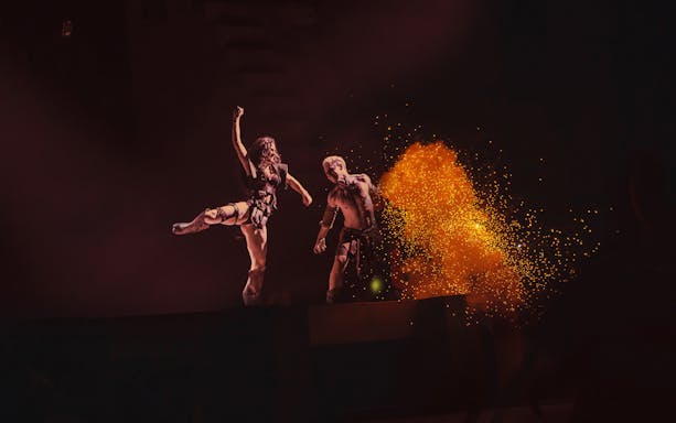 Performers on stage with fiery effects in MALINCHE, un musical de Nacho Cano.