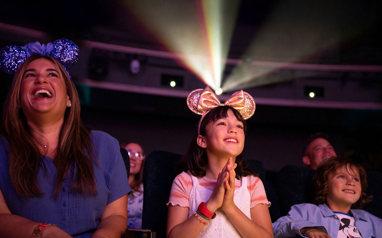 People enjoying a movie screening on Disney Adventure Cruise.