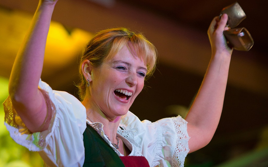 Performer at Tyrolean Evening Folk Show with Gundolf Family, holding cowbells.