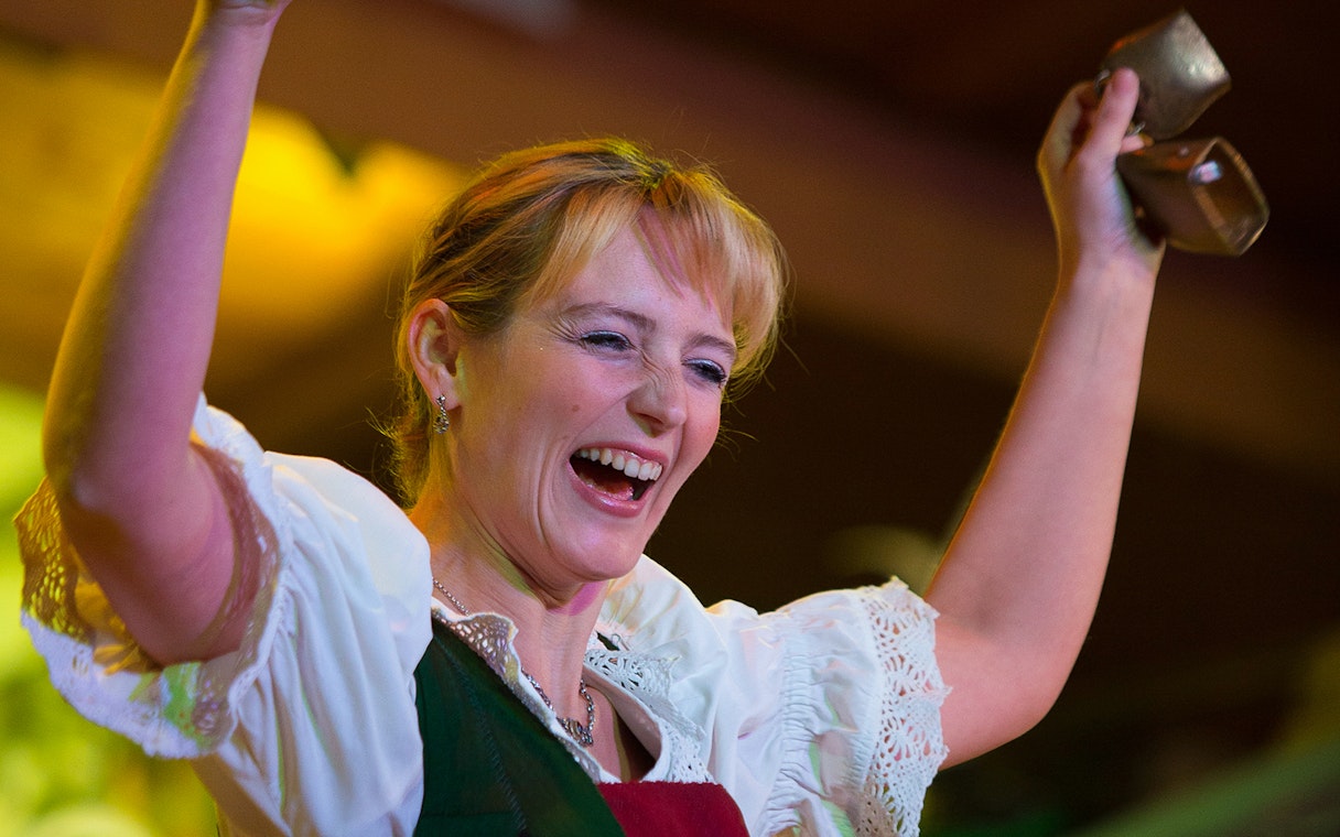Performer at Tyrolean Evening Folk Show with Gundolf Family, holding cowbells.