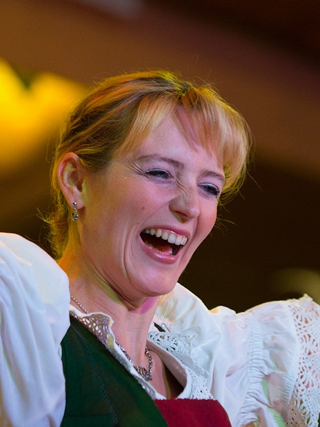 Performer at Tyrolean Evening Folk Show with Gundolf Family, holding cowbells.
