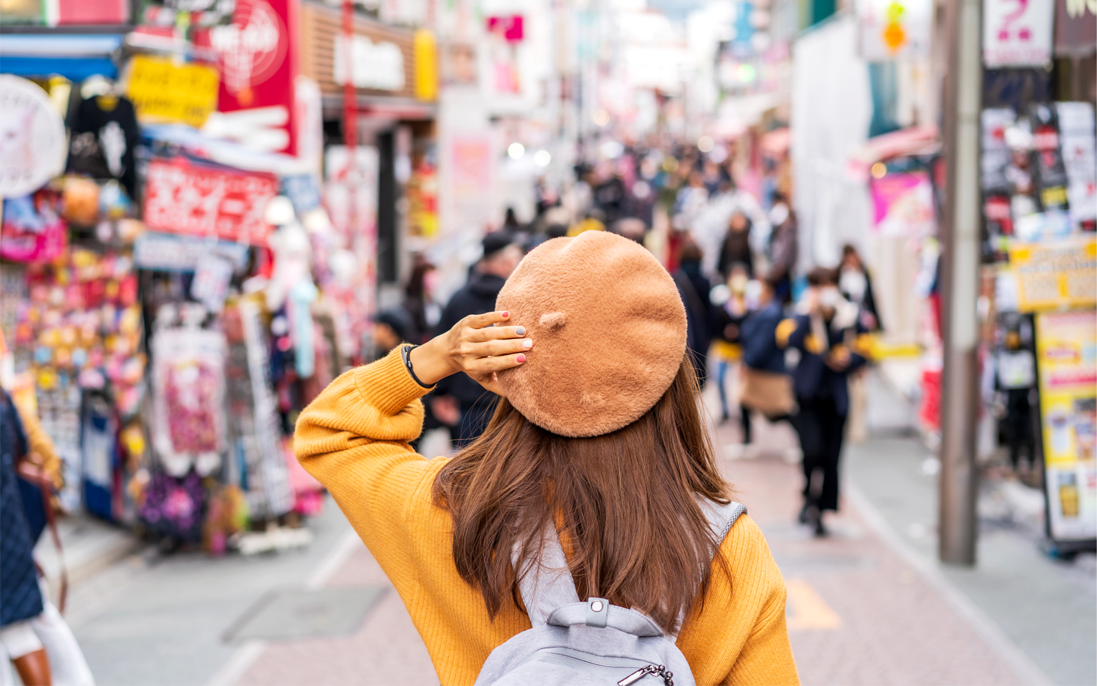 Traveler exploring Takeshita Street in Harajuku, Tokyo.
