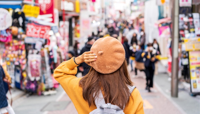 Traveler exploring Takeshita Street in Harajuku, Tokyo.