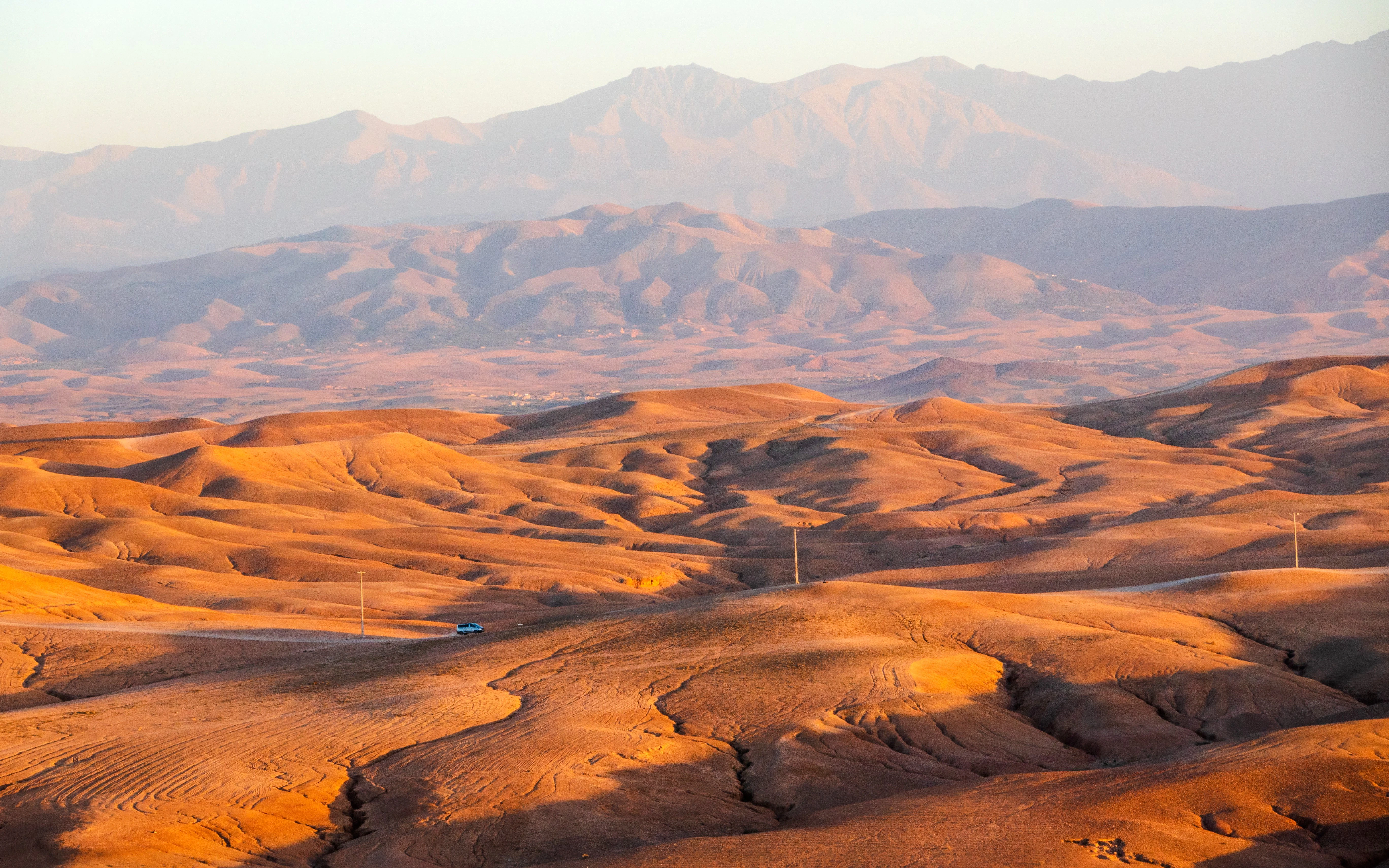 Sunset over the rolling dunes of the Agafay Desert near Marrakech, Morocco.