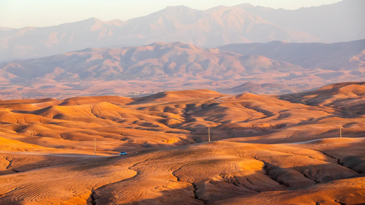 Sunset over the rolling dunes of the Agafay Desert near Marrakech, Morocco.
