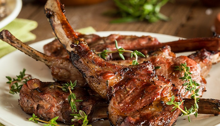 Grilled lamb chops with herbs on a plate, Athens in October.