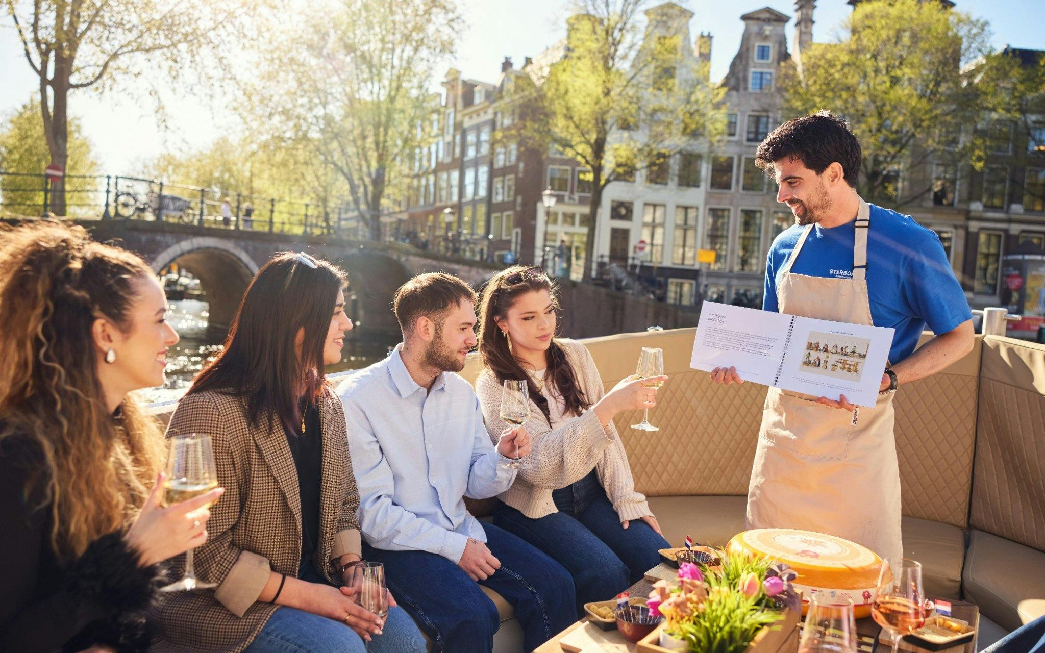 Guests enjoying a City Highlights Cruise on a luxury flower boat in Amsterdam.