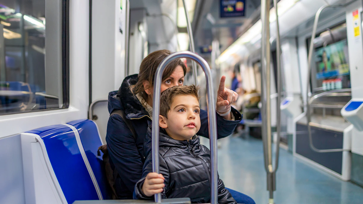 Mother and child riding Barcelona metro with Hola Barcelona Travel Card.