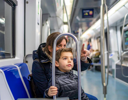 Mother and child riding Barcelona metro with Hola Barcelona Travel Card.