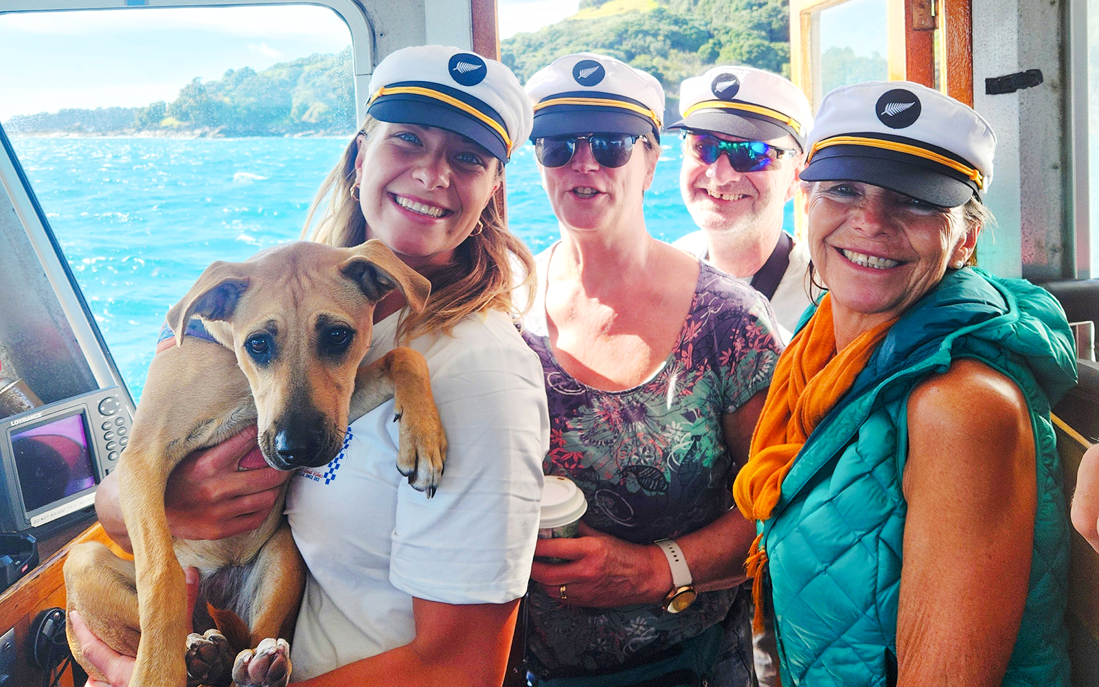 Group on a boat with a dog during a Dolphin & Wildlife Cruise.