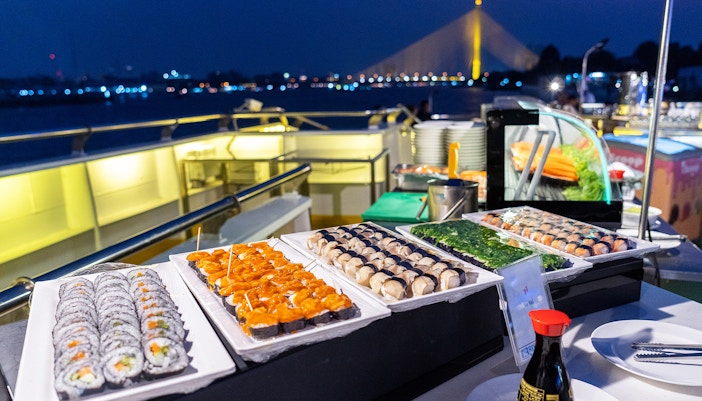 Sushi buffet on a Nile cruise dinner with illuminated bridge in the background.