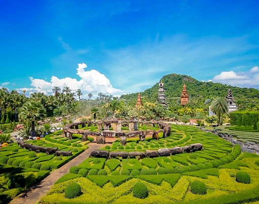 Nong Nooch Tropical Garden, Pattaya, vibrant floral displays and traditional Thai architecture.