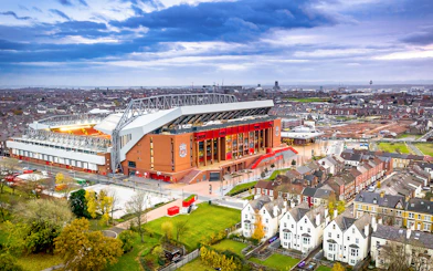Aerial view of Anfield Stadium in Liverpool surrounded by residential area.