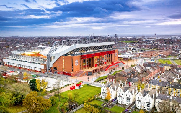 Aerial view of Anfield Stadium in Liverpool surrounded by residential area.