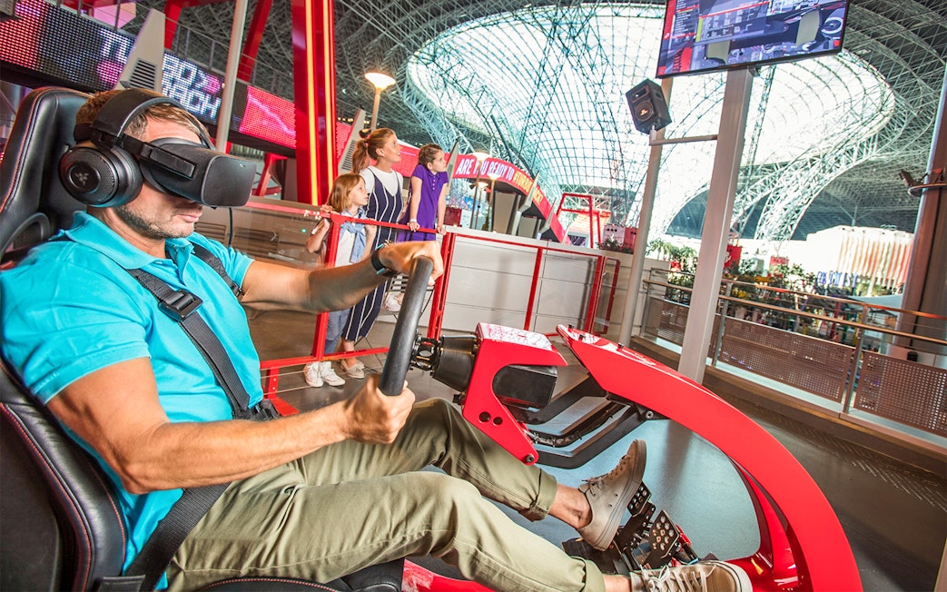 Man experiencing virtual reality ride at Ferrari World Abu Dhabi.