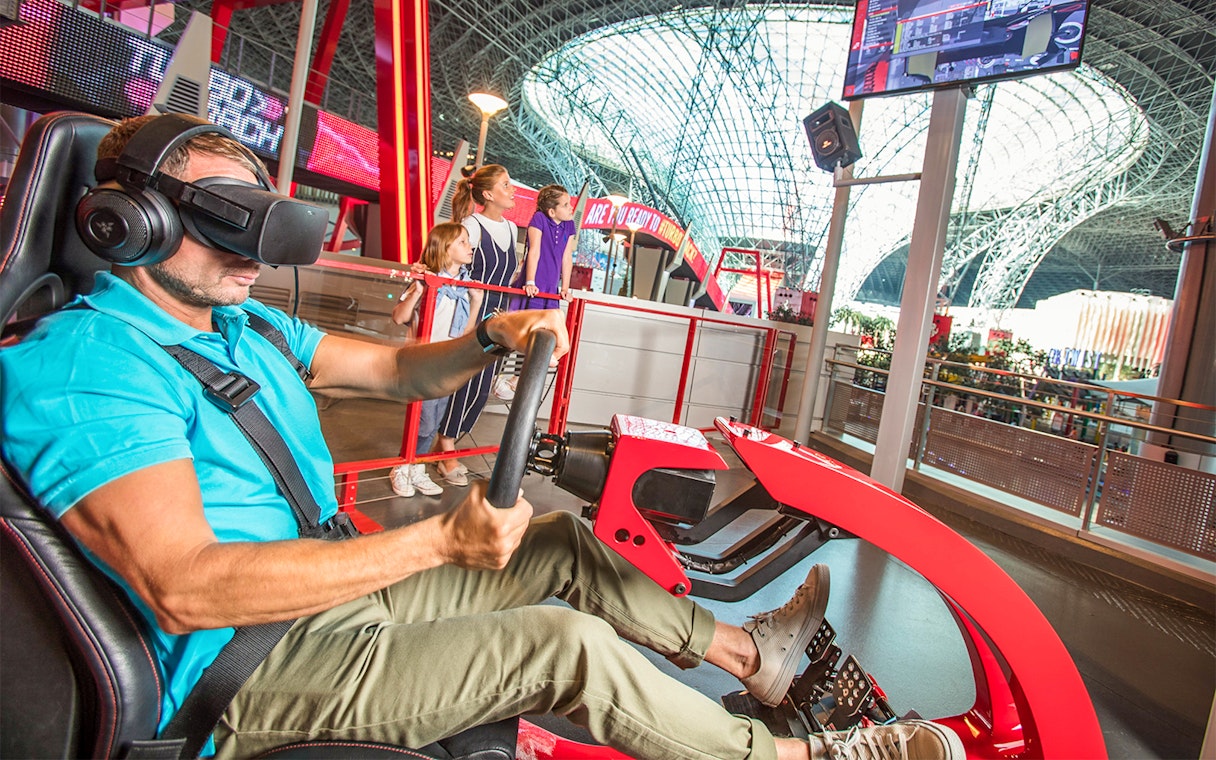 Man experiencing virtual reality ride at Ferrari World Abu Dhabi.