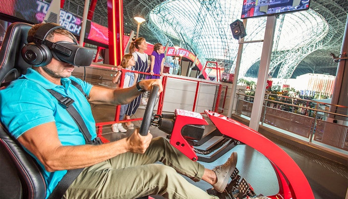 Roller coaster at Ferrari World Abu Dhabi with red tracks and high-speed loops.