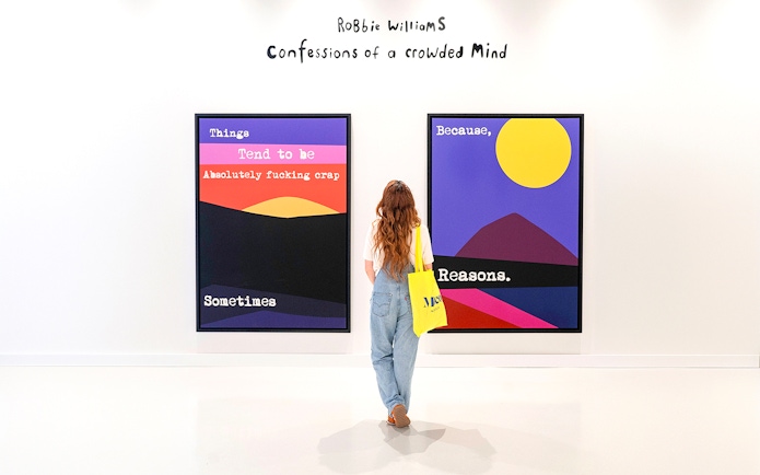 Visitor viewing colorful artwork at Moco Museum Barcelona exhibition.