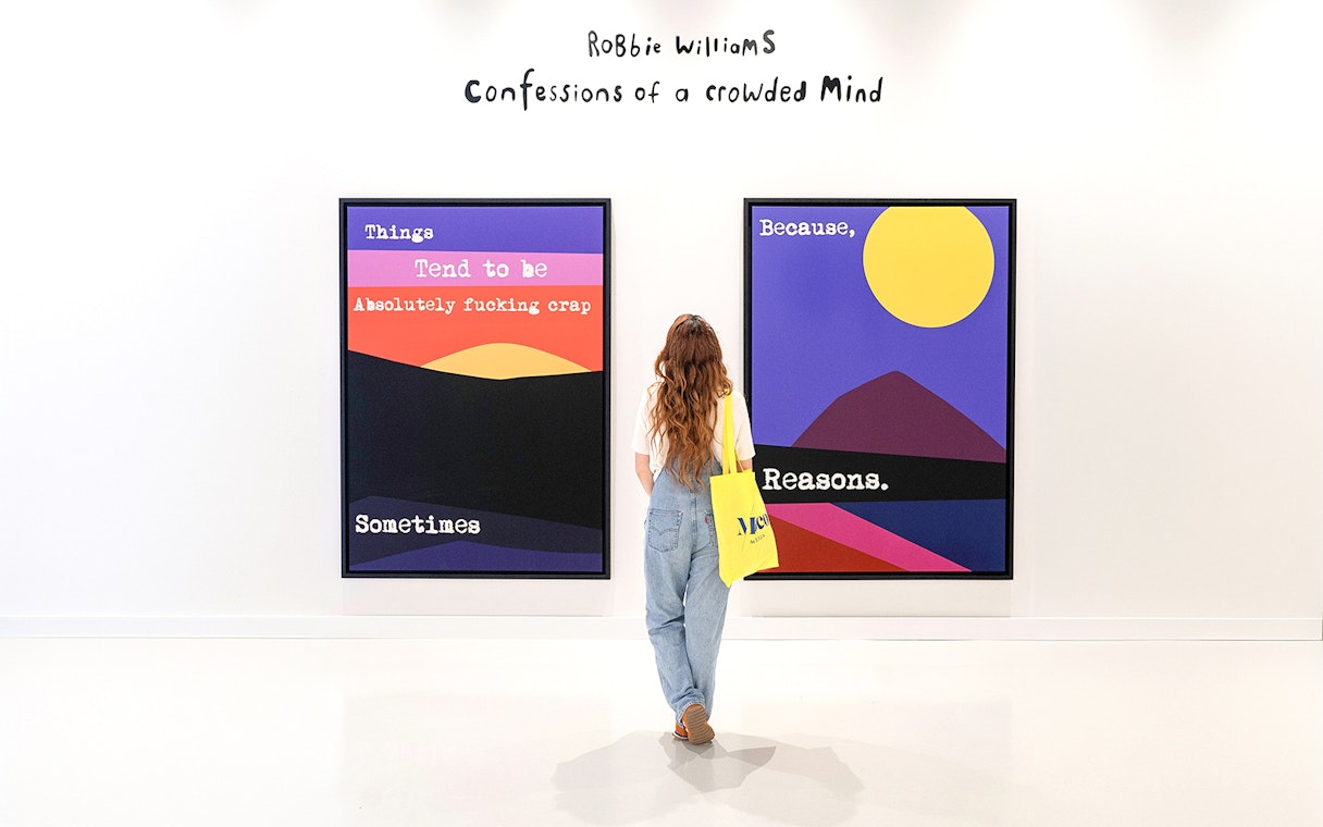 Visitor viewing colorful artwork at Moco Museum Barcelona exhibition.