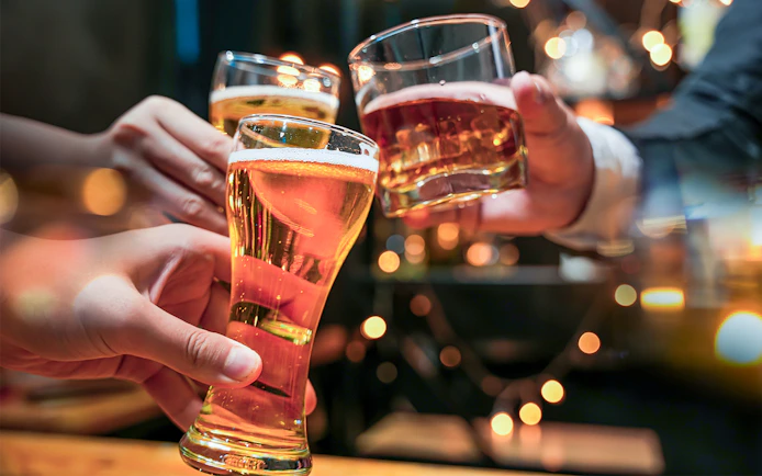 Glasses of beer and alcohol being cheered on a cruise.