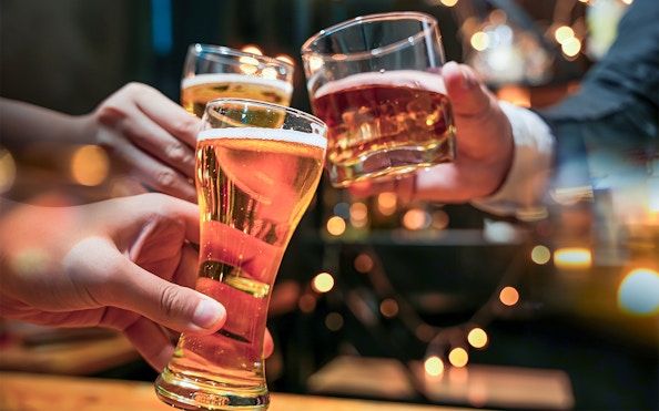 Glasses of beer and alcohol being cheered on a cruise.