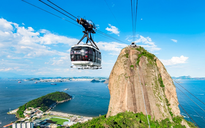 Cable car ascending Sugarloaf Mountain, Rio de Janeiro, with ocean view.